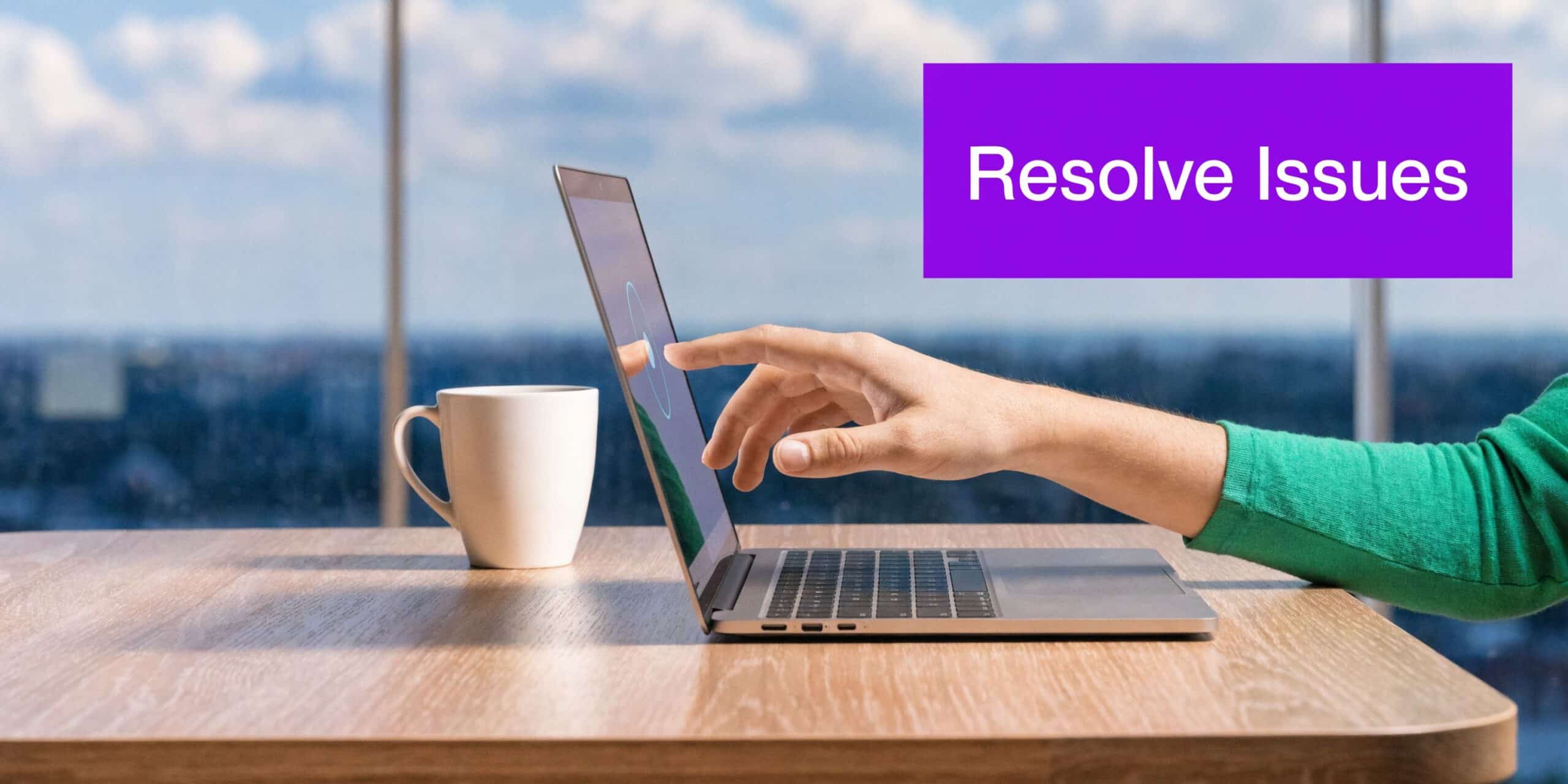A person using a laptop with a modern office background while pointing at the screen.