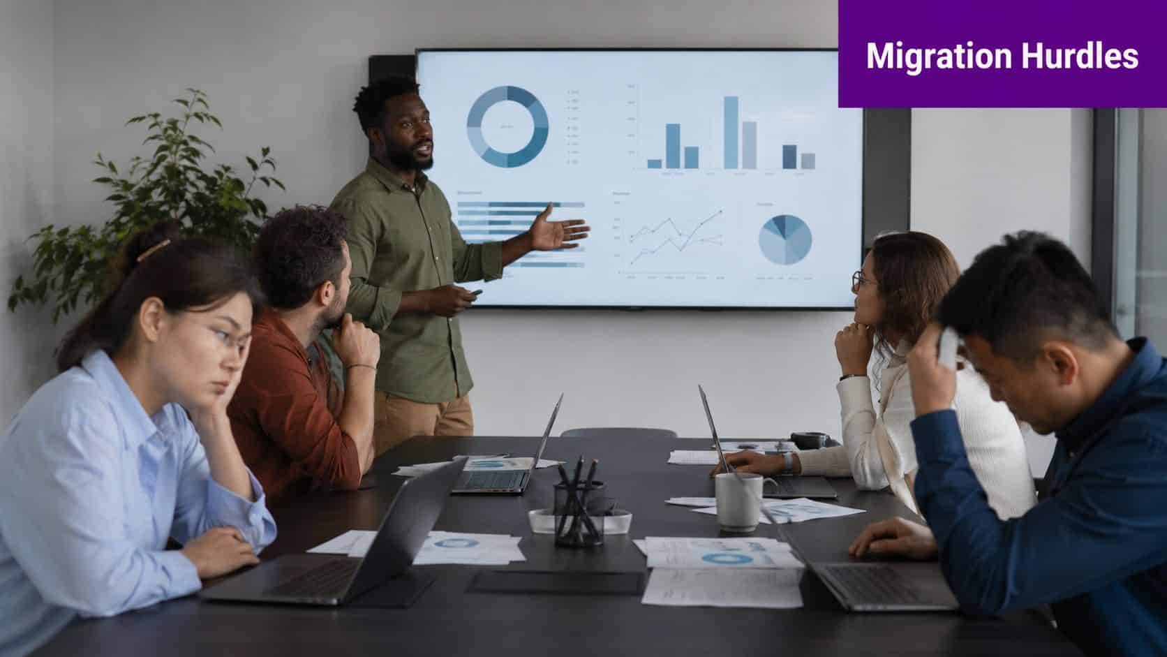 A diverse group of colleagues looking frustrated and tired during a business presentation in an office meeting room.